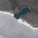 Mini lake meets snowy rim of Canada’s oldest ice mass — Earth from space